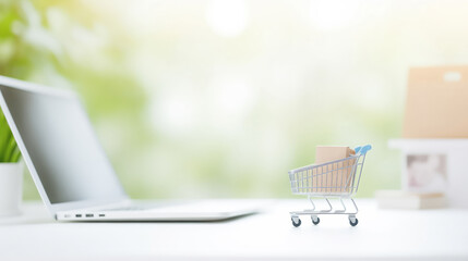 Concept banner online shopping E-commerce. Mini Tiny cart with boxes beside laptop with blur background