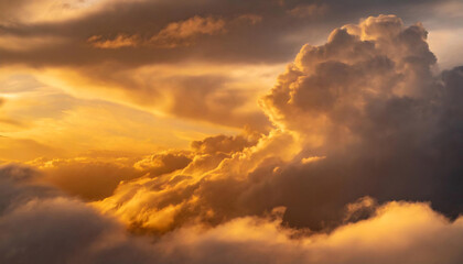 Naklejka na ściany i meble Golden sunlight piercing through dramatic clouds during sunset, creating an ethereal glow.