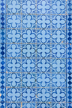 Original portuguese mosaic of tiles in blue. Geometrical shapered with marks of time. 