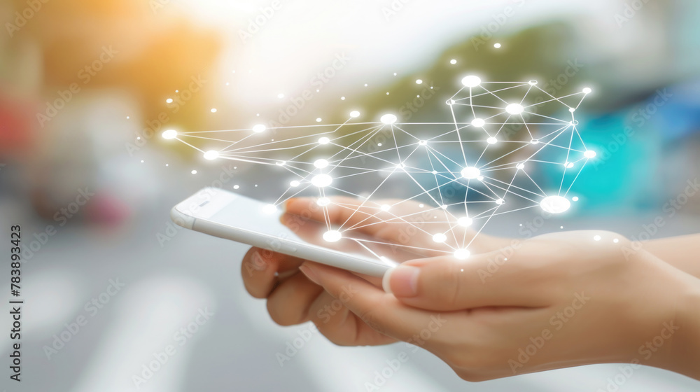 Poster a persons hand holds a smartphone that displays luminous, interconnected network graphics symbolizin