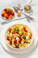 tortellini salad with tomatoes, mozzarella in bowl