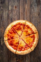 Margherita Pizza with tomato sauce and mozzarella cheese on wooden background
