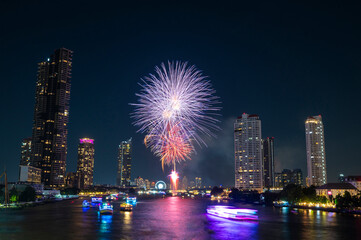 Fototapeta premium Landscape of firework at Taksin Bridge with chaopraya river. downtown Bangkok City Thailand.