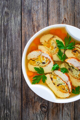 Baked stuffed turkey sliced fillet in jelly and vegetables on wooden table
