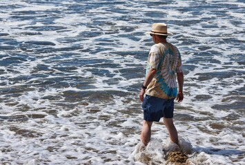 Wading in the Pacific Ocean, cool water on a warm sandy beach.