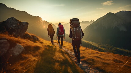 Group of sporty people walks in mountains at sunset with backpacks. Mountain travel hike people adventure man summer journey tourism group sunset trekking