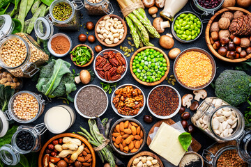 Vegan food background. Plant protein., vegetarian nutrition sources. Healthy eating, diet ingredients: legumes, beans, lentils, nuts, soy milk, tofu, cereals, seeds and sprouts. Top view, black table - 783907042