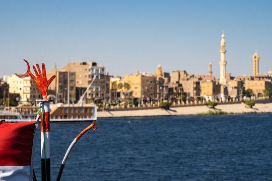 The corniche of Esna town with the egyptian flag from the Nile river in Egypt