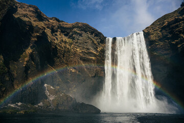 icelandic waterfall and a rainbow in a sunny day - obrazy, fototapety, plakaty
