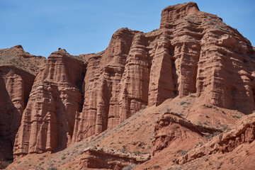 Sheer cliffs subject to erosion, red rocks of the Konorchek canyon, travel destination, famous...
