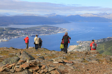 Tourists on the mountain Fløya with a view towards Tromsø city - 783913808