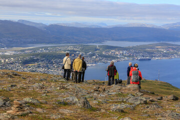 Tourists on the mountain Fløya with a view towards Tromsø city - 783913830