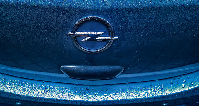 Spain, Madrid - April 13, 2024. Opel logo on bodywork on a rainy day.