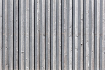 grey wooden wall with boards and fabric in between