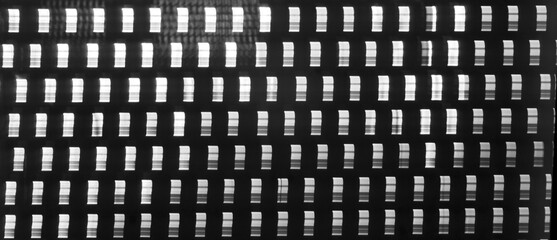 Metal parts with stripes pattern on black background.