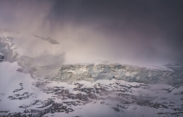 Texture of mountain ranges and peaks with snow and ice in the evening, in the Fan Mountains in...