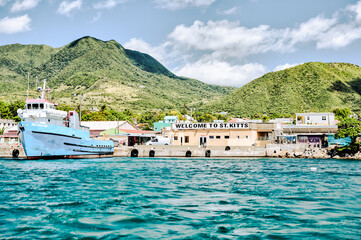 Charlestown, St Kitts and Nevis - March 28, 2028: Landscapes and vessels along the shores of St...