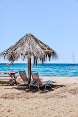 Charlestown, St Kitts and Nevis - March 28, 2028: Beach chairs, palapas and hammocks outside of the port town of Charlestown in Saint Kitts and Nevis
