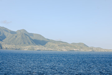 Charlestown, St Kitts and Nevis - March 28, 2028: Landscapes and vessels along the shores of St Kitts seen from the water
