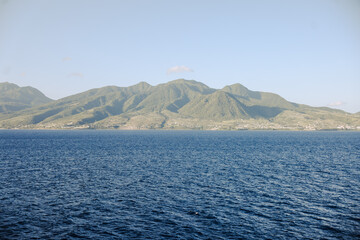 Charlestown, St Kitts and Nevis - March 28, 2028: Landscapes and vessels along the shores of St Kitts seen from the water
