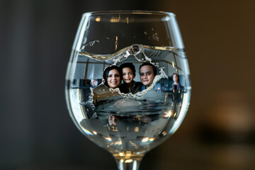 Family Reflection in Wine Glass - obrazy, fototapety, plakaty