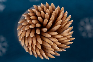 Set of wooden toothpicks arranged in a circular shape viewed from top to bottom