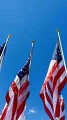 American flags on poles against blue sky. Patriotism and national celebration concept.