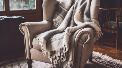 Scandinavian textile blanket on the armchair, giving comfort and warmth - 783941830