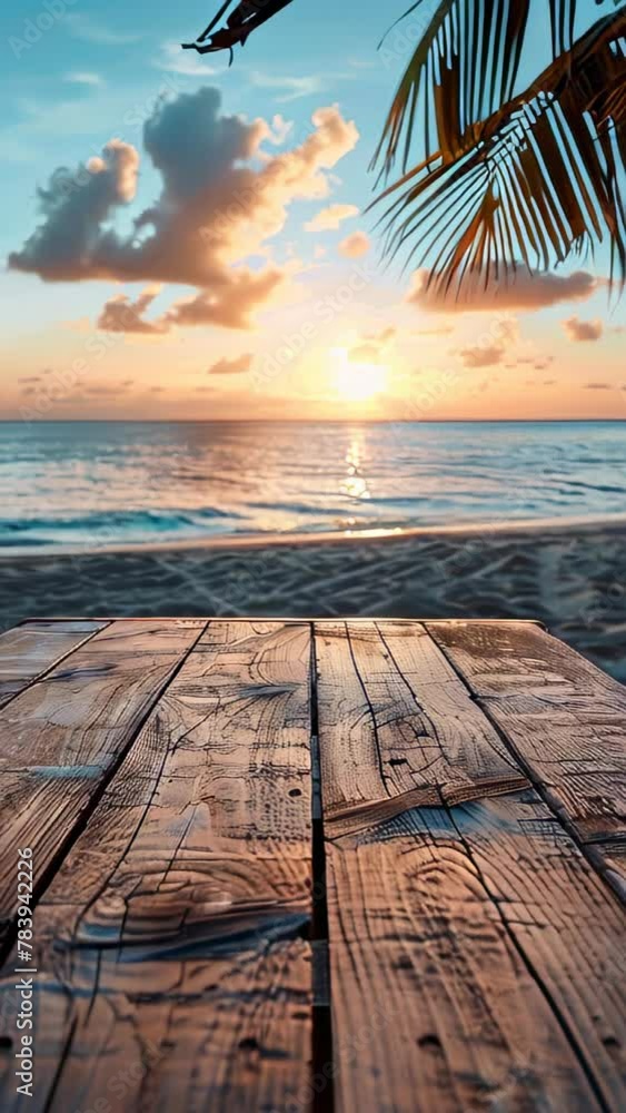 Poster a wooden table is on a beach with the ocean in the background. the table is empty and the sky is a b