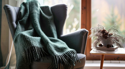 Scandinavian textile blanket on the armchair, giving comfort and warmth - 783942412