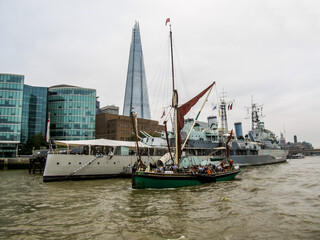 A single mast sail ship, part of the tall ship festival, sailing down the River Thames, London, UK,...