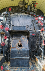 Valves and gauges on the water tank in the cab of an antique steam locomotive