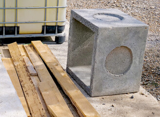 Reinforced concrete cube on a construction site with building materials