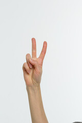 Female hand showing peace sign or victory sign.