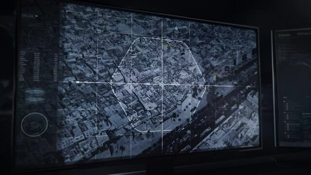 Dark computer monitor. Modern security drone. Drone is flying over the city's buildings. Data appears on screen. Sfax city Tunisia. National security agency is performing a security scan of the city.