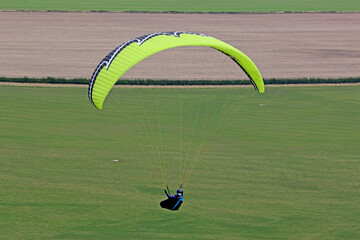 Paraglider flying from a hill