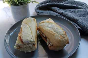 Chicken salad on a toasted baguette bun for lunch.