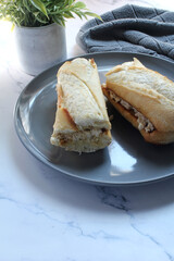 Chicken salad on a toasted baguette bun for lunch.