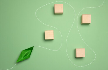 A green paper boat and a trajectory with obstacles, a detour around the path.