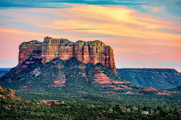 Courthouse Butte with orange clouds at sunset from the Airport Mesa overlook in Sedona Arizona