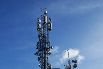 Mobile communication tower on the background of the sky. High quality photo