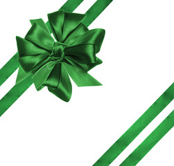 Tied bow made of green silk ribbon on an isolated background, decor for a gift.