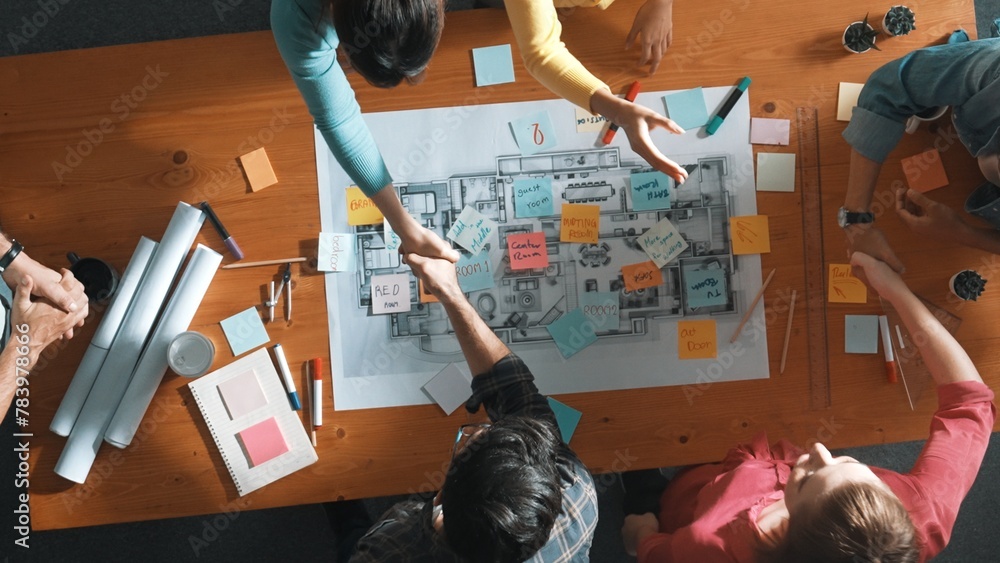 Poster top down view of smart business people shaking hands and making a contract. aerial view of architect