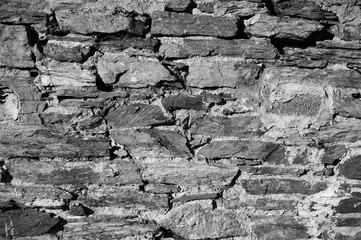 Fragment of a very old stone wall. Background textute.
