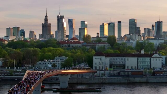 Warszawa, Poland - April 9, 2024: The panoramic view of downtown Warsaw boasts a vibrant mix of monuments and modern skyscrapers, framed by the shape of the newly opened pedestrian and bicycle bridge