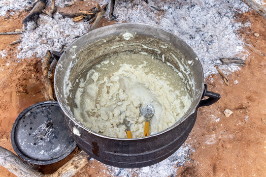 cooking pap in large 3 legged pots ,traditional event, outdoors kitchen africa