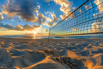 Beach volleyball net stretches across a sandy beach with waves gently lapping the shore and the sun...