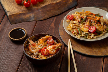 shrimp udon and rice yaki soba sauce on a round stand next to soy sauce and chopstick