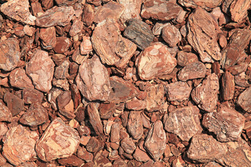 Wooden texture, background with chaotic location of elements. Mosaic pattern of an innovative type of floor. Pine bark or mulch carpet. Timber product for the garden covering or children playgrounds