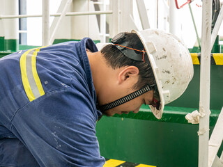 Seaman crew member of cargo vessel  equipped with personal protective equipment is painting vessel...